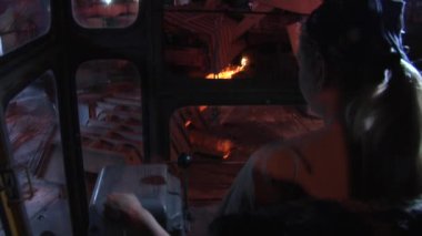 Woman Worker Woman's Back Fair Hairs Crane Driver in The Cabin of Crane Factory through the Cabin Windows Top Down Workers Men in Safety Helmets