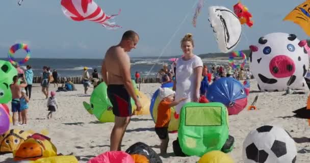 Lucht zwemmers in het zand - mensen hun vliegers voorbereiden om te vliegen op International Kite Festival in Łeba, Polen — Stockvideo