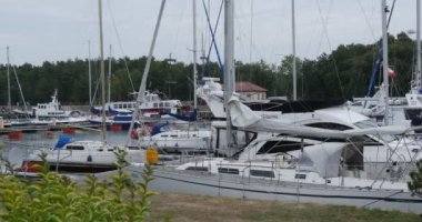 White Yachts Are Laid Up Yacht Club Port Ship Floats On The Water People Walk On The Shore Safe Harbor Calm Water Cloudy Summer Day