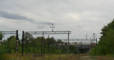 Demiryolu parça yeşil ağaçlar bulutlu sonbahar gün elektrikli demiryolu iletişim ağının kişi destekliyorsa