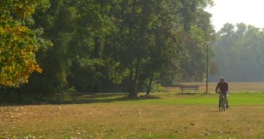 Park Alanı Tezgah Lamba Post Ağaçlar Sunny Sonbahar Günü Opole Polonya Kuru Çim ile Çim De Bisiklet Üzerinde Man Rides