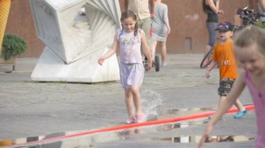 Dört çocuk sokakta güçlü bir yağmur sonra oyun.