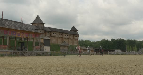 Trzech aktorów jak Vladimir wielki, Prince Vladimir i dwóch wojowników, żołnierzy w dawnych strojach są Galloping, aparat Aproaching, starożytne mury miejskie — Wideo stockowe