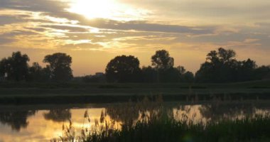Parlak Sunsen arkasında göletin üzerine sarı Cumulus
