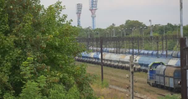 Särskilda rullande materiel flyttar på järnvägen spår två godståg stå på järnvägen järnvägen kontaktnät lampa inlägg ingångs lampor regnig dag — Stockvideo