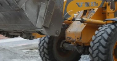Sarı Ekskavatör Sürücü Turuncu İş Elbisesi Sunny Granit Toz Onarım City Street İşçileri Taşır Granit Toz Unloads Makine Açar