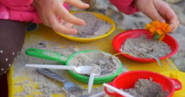 Küçük Kız Eller Close Up Kum Oyuncak Yemekleri Oyuncak Yemekleri Oyuncak Gıda Çatal Kaşık Kız Ile Cook Oyuncak Tabak ve Pan Oynuyor Sandbox Outdoors Sonbahar Oynuyor