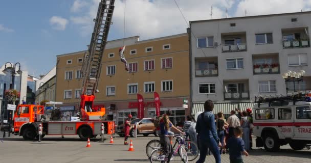 Feuerwehrmann zieht das Seil Kind auf dem Seil Gruppe von Menschen stehen und suchen Mann in Arbeitskleidung Ausbildung der Rettung von Kindern aus Gebäuden — Stockvideo