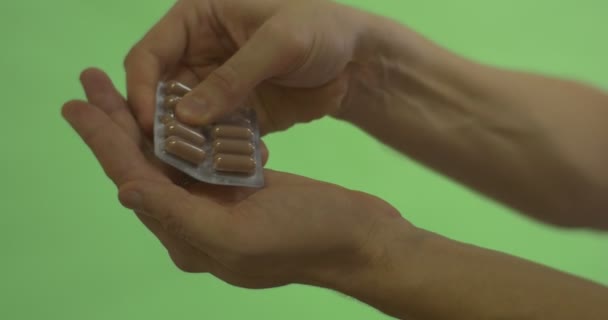 Male Hand in Golden Wedding Ring Takes Caplsule Pills Off the Blister Holding a Capsules on a Palm for a While Took Another One Took the Hand Away — Stock Video