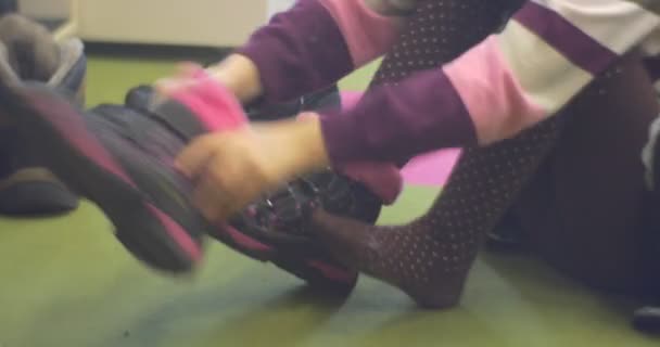 Meisje jurken de laarzen versierd met roze bont. — Stockvideo