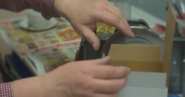 Biri koyarak bir altın topu içine bir kutusu makine tekerlek döner testere dışarı bir cam tutamacını bir Noel oyuncak verir buna için bir kişi kim yapılmış olduğunu