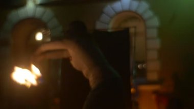 Woman Dancer is Rotating Holding a Fire Torches Old Building is Behind Performing a Fire Dance Slow Motion Dangerous Tricks at Fire Show in Opole Evening