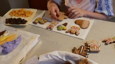 Kadın alır bir adam-Cookie resminden bir Noel kurabiye bisküvi dekorasyon dekore bir sepet üzerinde bir tablo çikolata renkli Mastique ile düğmeleri