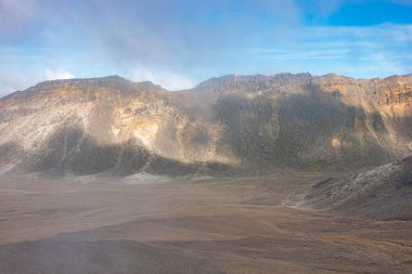 Slopes, light and shade on hillsides of mountains along Tongariro Alpine Walk in New Zealand.