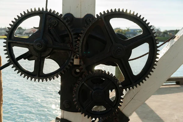 Set of three gear wheels on wharf designed in increase power or torque lifting heavy items.