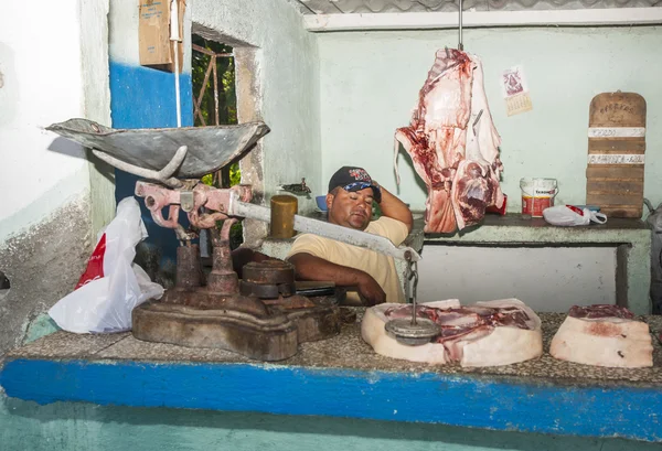 July 7, 2012; Cuban butcher shop at a not busy moment with meat hanging in open air and the butcher asleep behind the counter at a time before the relaxation of the US embargo.