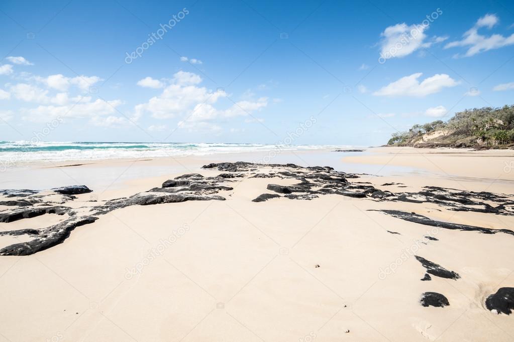 Beautiful sandy ocean beach on Fraser Island on summer day Queensland Australia.