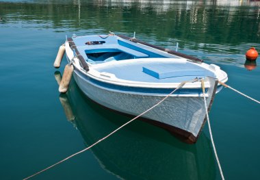 Moored traditional style boat on calm water Croatia clipart