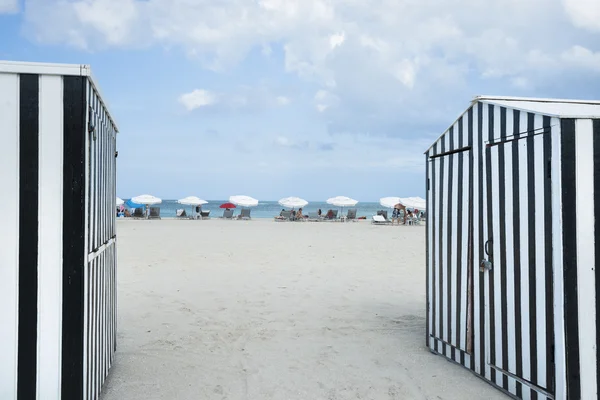 South Beach framed by black and white striped shed in Miami.