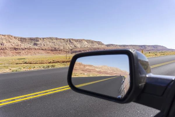 Road and landscape in rear vision mirror through  Arizona. — Stock Photo, Image
