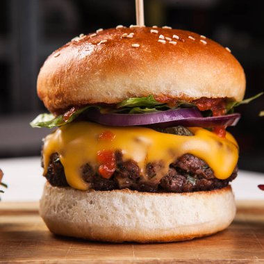 Lezzetli burger, sulu biftek, sos ve peynir.