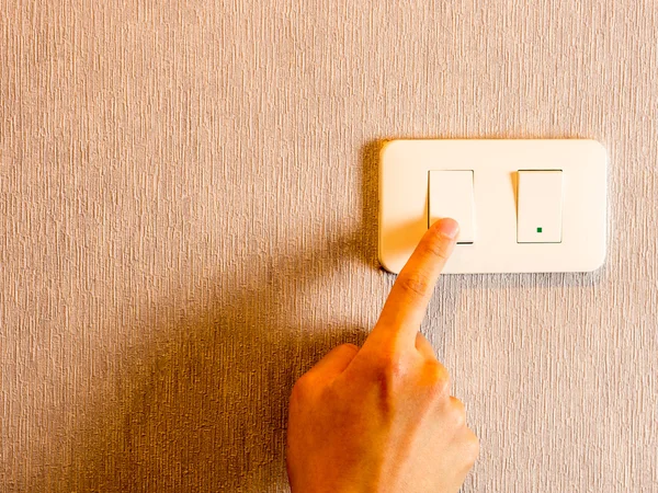 Man hand on light switch, cool color filter — Stock Photo, Image
