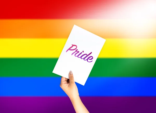 Pride on card with hand holding; LGBT color flag — Stock Photo, Image