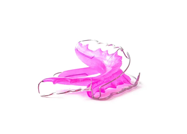 Beyaz arka plan üzerinde izole pembe Diş telini orthodontia