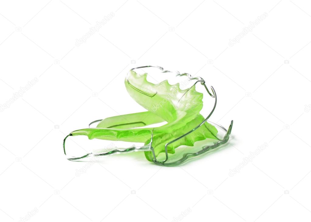 Green dental retainer orthodontia, isolated on white background