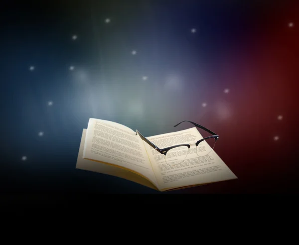 Abstract book and eye glasses on galaxy glowing light background — Stock Photo, Image