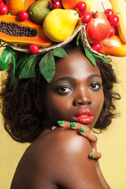 Beauty portrait closeup of a young pretty girl with fruit tree on her head. clipart