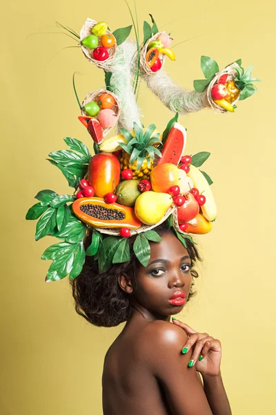 Beauty portrait closeup of a young pretty girl with fruit tree on her head. — Zdjęcie stockowe