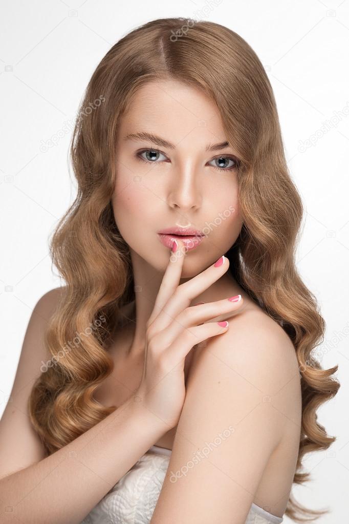 Beauty portrait closeup of young beautiful model girl with natural fresh daily makeup and great hairstyle hollywood wave, french pink manicure.
