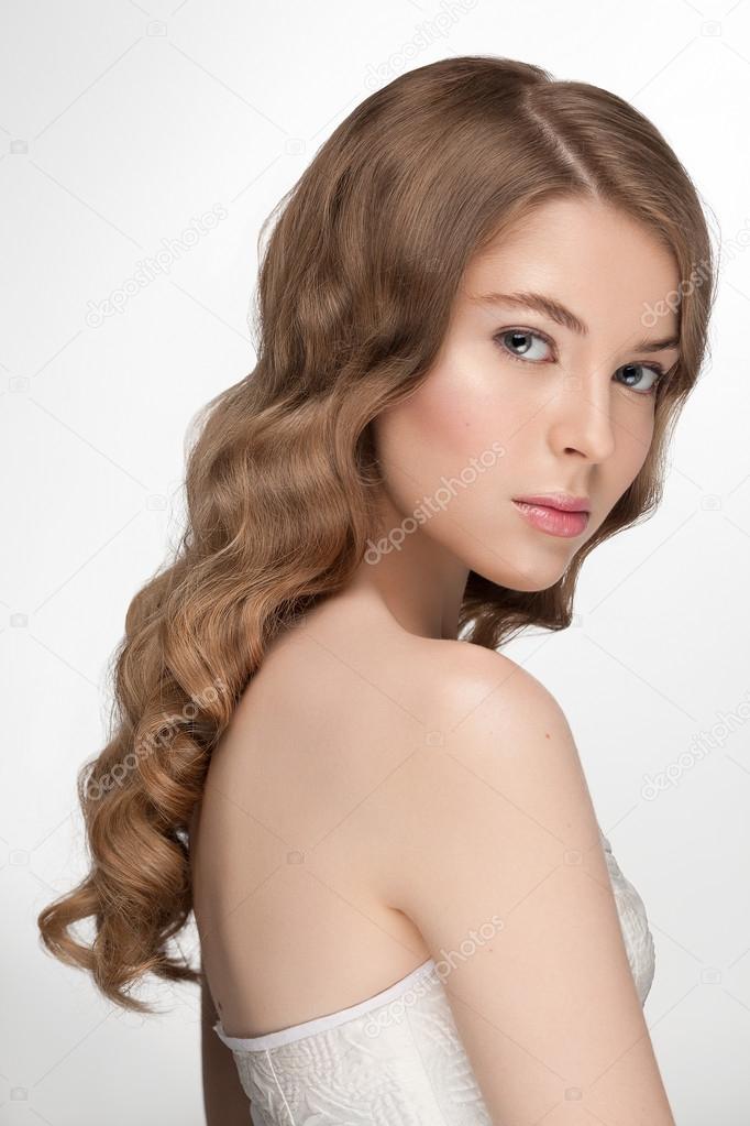 Beauty portrait closeup of young beautiful model girl with natural fresh daily makeup and great hairstyle hollywood wave, french pink manicure.