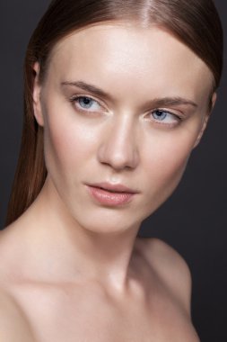 Young woman with nude makeup.