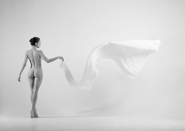 Sensual naked woman holding white cloth