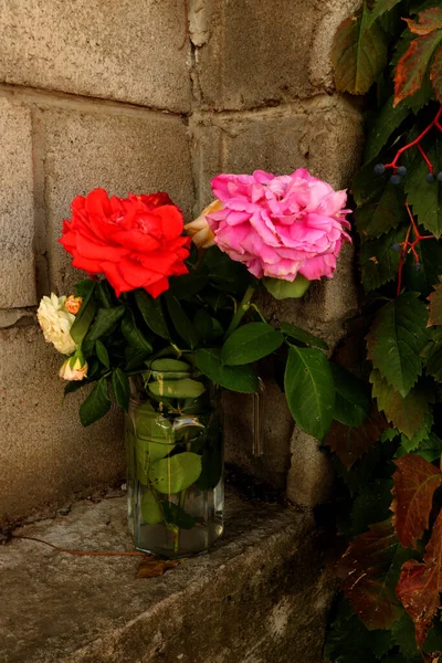 roses bouquet on old brick wall background