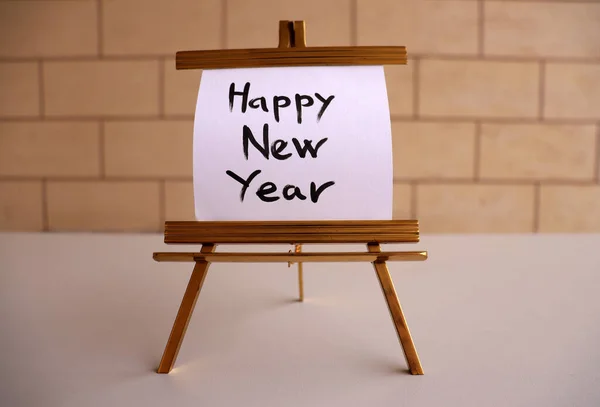 new year 's card with text happy new year on a wooden background.