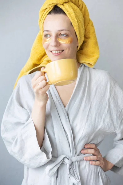 young and beautiful caucasian woman with patches under her eyes to protect and moisturize the skin