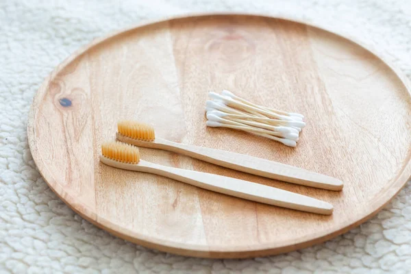 Environmentally friendly bamboo and cotton cotton buds on a pink background, bamboo toothbrushes for adults and children. human personal hygiene products without harming the environment — Stock Photo, Image