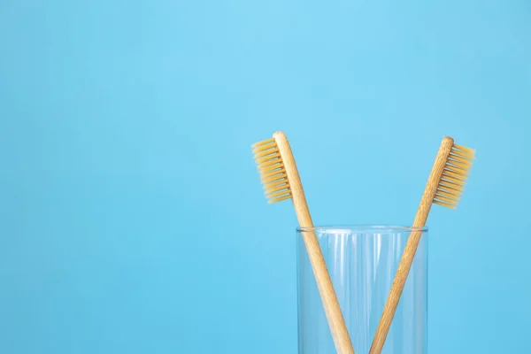 bamboo toothbrushes on a blue background in a glass, eco-friendly personal care products for people who care about the breed