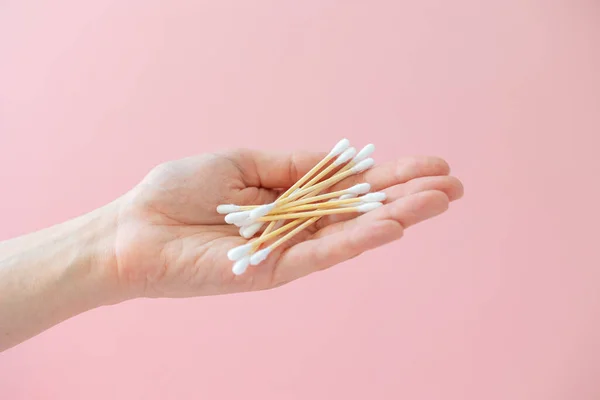 environmentally friendly bamboo and cotton cotton buds on a pink background, bamboo toothbrushes for adults and children. human personal hygiene products without harming the environment