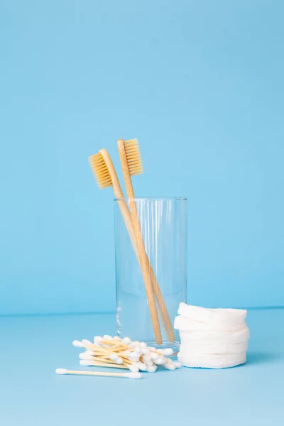 bamboo toothbrushes on a blue background in a glass, eco-friendly personal care products for people who care about the breed