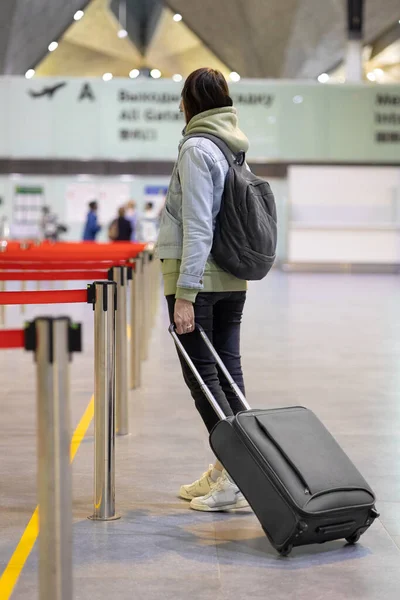 Mujer europea en el aeropuerto esperando abordar sus retrasos de vuelo, vuelo y embarque — Foto de Stock