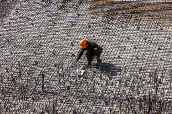 stock image builders in hard hats and protective vests work at the construction site of a multi-storey building