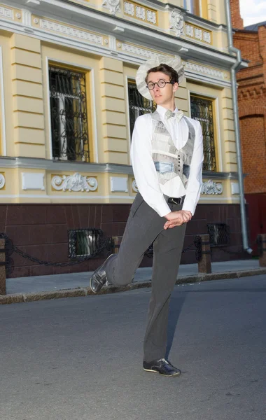 Young man in fashionable clothes strolls on city street — Stock Photo, Image