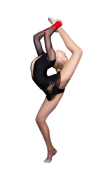 Flexibilní mladá gymnastka provádí prvek v ateliéru — Stock fotografie