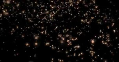 Uçan soyut parçacıklar. Bokeh etkisi. Çok renkli parçacıklar siyah arkaplanda uçar. Yatay bileşim, 4k video kalitesi