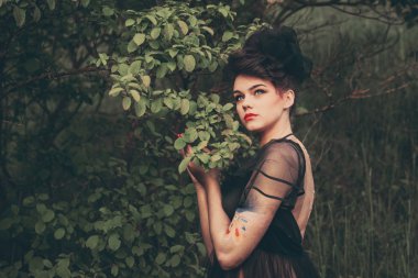 Doğanın bir arka plan üzerinde güzel elbiseli çekici kız