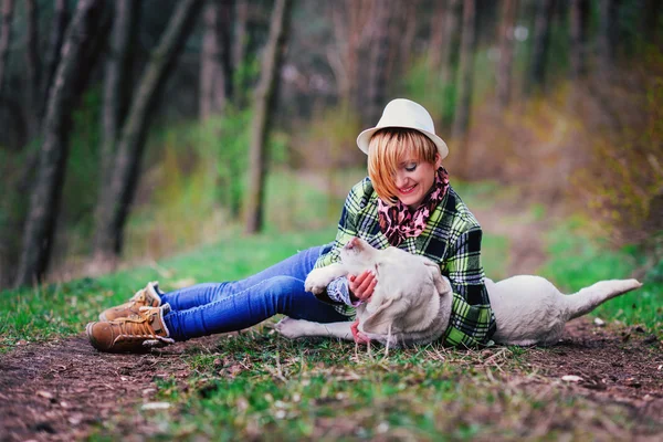 Młoda dziewczyna z psem w drewnie — Zdjęcie stockowe